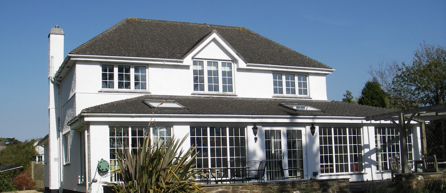 A white house with a grey roof
